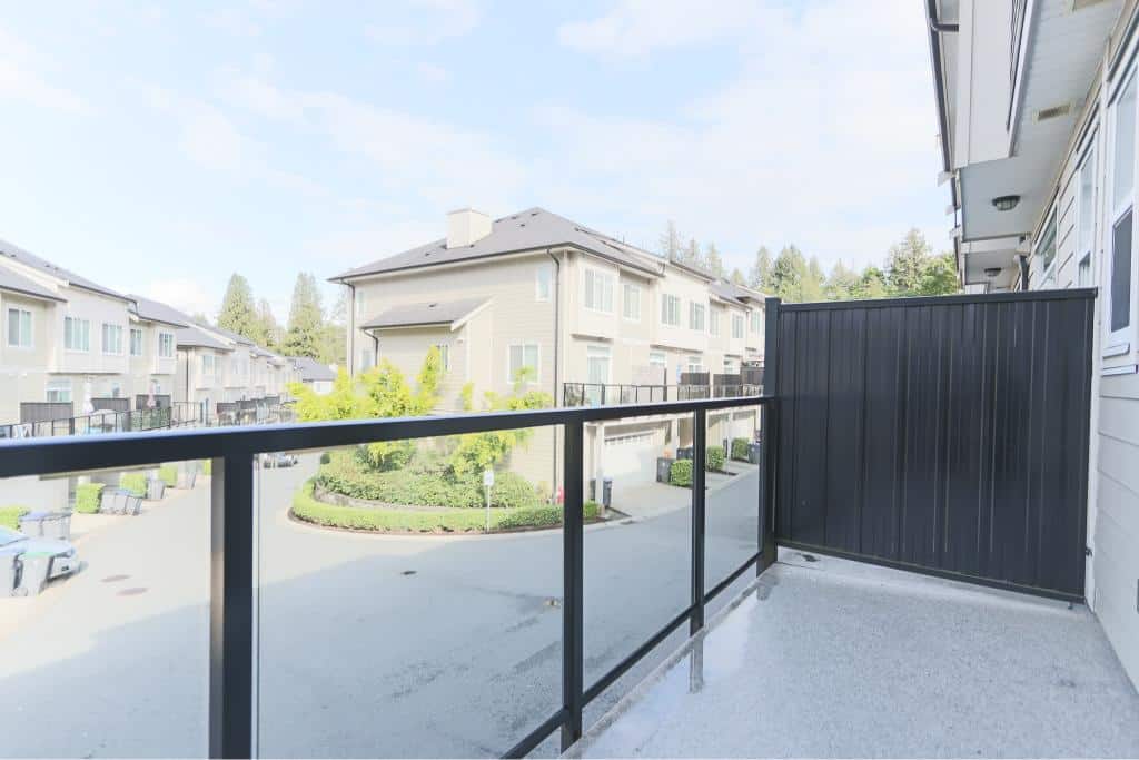 Modern balcony view of a residential community in Canada, showcasing contemporary townhomes and lush greenery, perfect for real estate marketing in Vancouver and surrounding areas.
