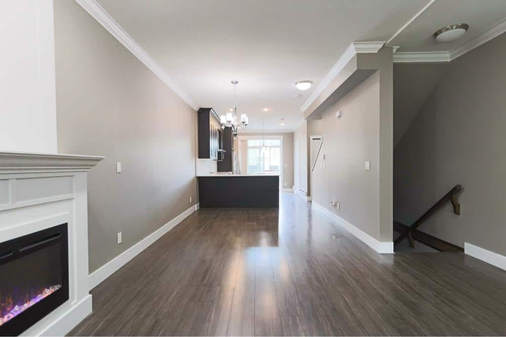 Modern open-concept living room with fireplace, neutral wall colours, hardwood floors, and contemporary design, ideal for Vancouver real estate and residential living.