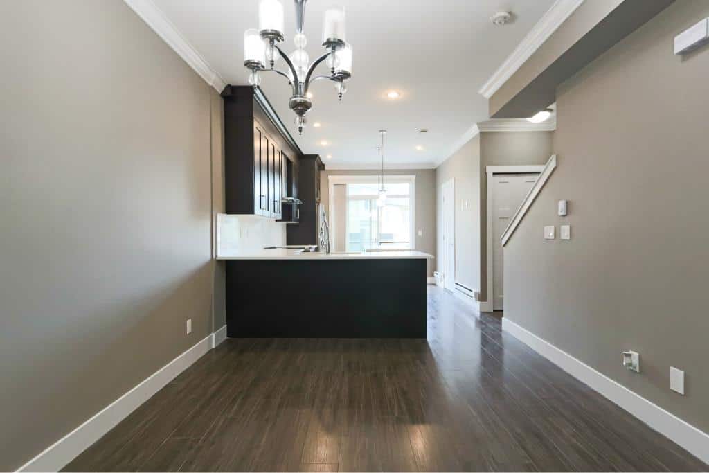 Modern open-concept kitchen and living space in a Vancouver-area home, featuring stylish cabinetry, a sleek island, and contemporary lighting, ideal for real estate listings in BC.
