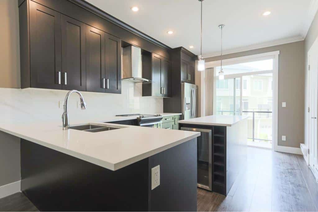 Spacious modern kitchen with dark cabinetry and stainless steel appliances, ideal for Vancouver property buyers.