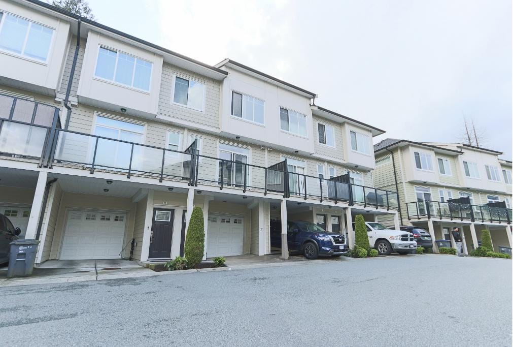 Spacious modern multi-family townhomes with attached garages and balcony terraces in a contemporary residential complex in BC. Perfect for families and investors seeking prime real estate.