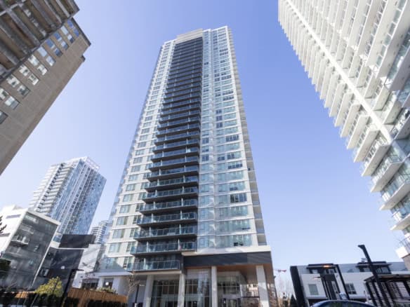Contemporary high-rise condominium building in downtown Vancouver with glass exteriors and spacious balconies. Modern urban living with scenic city views in a vibrant neighbourhood.