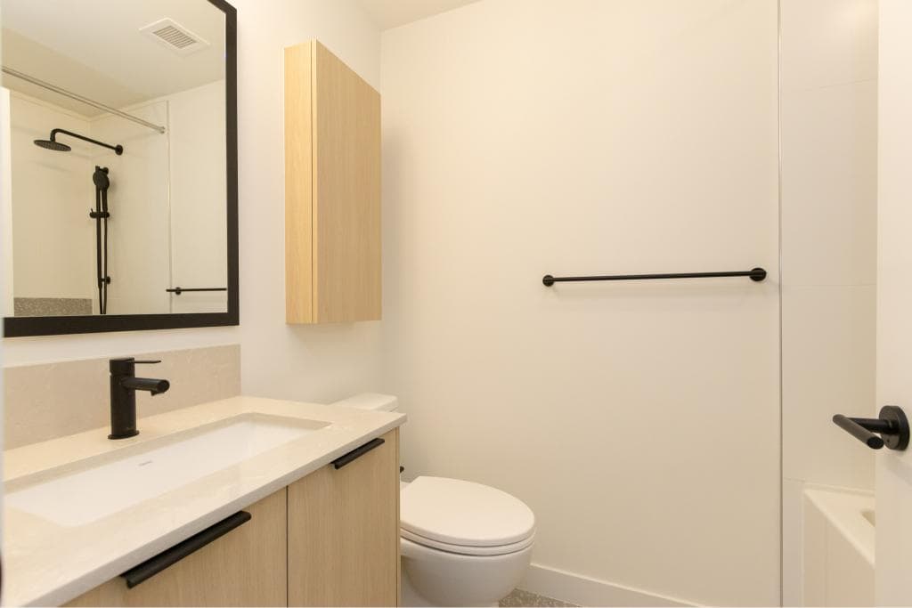 Modern bathroom interior with neutral tones, black fixtures, and minimalist design, perfect for Vancouver-area homes and real estate listings.