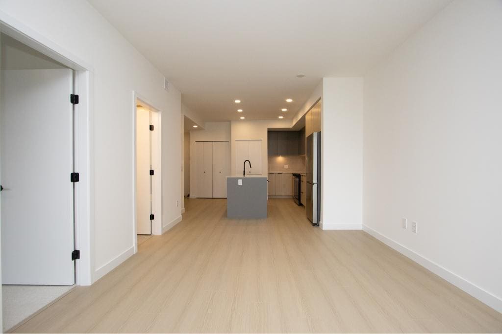 Bright modern open-concept kitchen and living space in Vancouver, BC, showcasing contemporary design and minimalist decor, ideal for homebuyers looking for sleek residential properties.