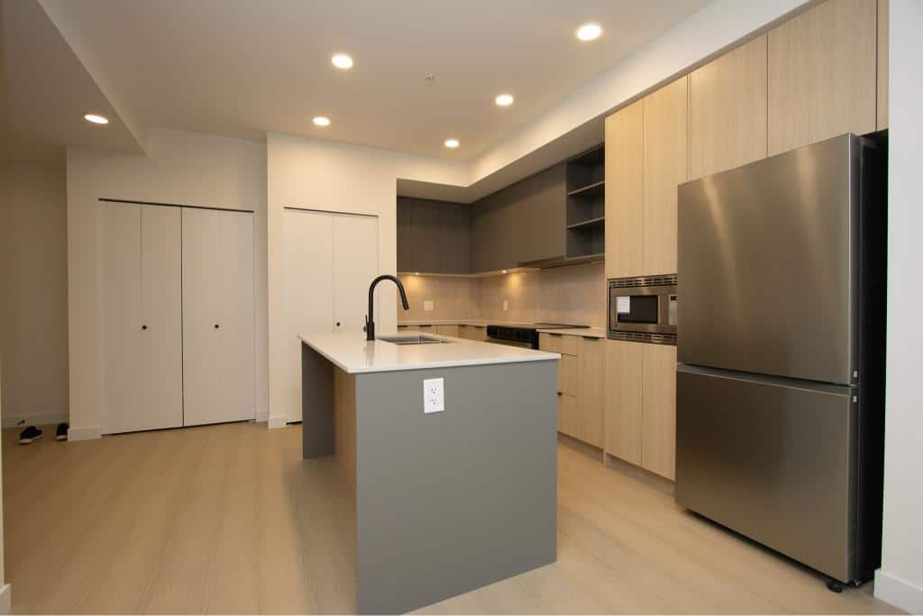 Modern kitchen interior with stainless steel appliances, minimalist cabinetry, and neutral tones, ideal for Vancouver homebuyers and real estate investments.
