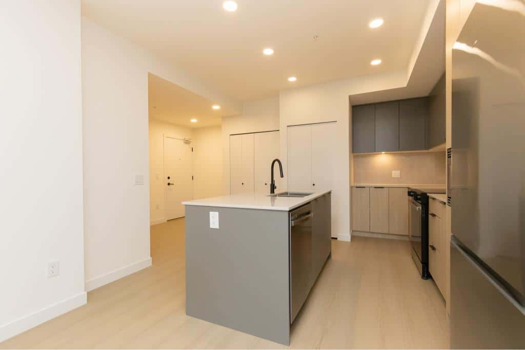 Modern kitchen with sleek cabinetry and an island, perfect for Vancouver homes, by Orca Realty Inc.