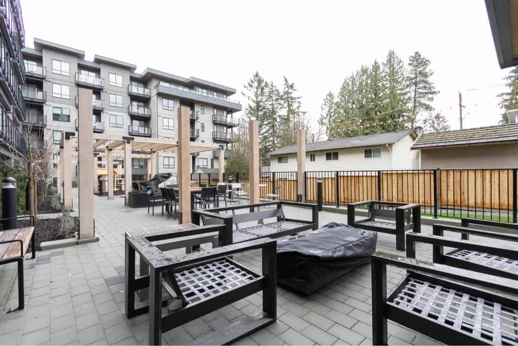Modern outdoor patio area with seating and barbecue at Orca Realty Inc. showcasing Vancouver's vibrant real estate and property management services.