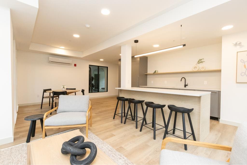 Modern Vancouver Island apartment interior featuring an open-concept kitchen and living space, ideal for real estate listings and property marketing.