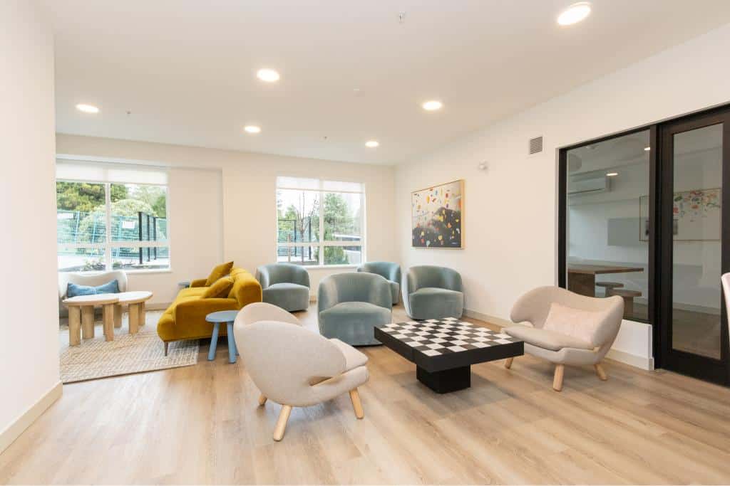 Modern condo common area with stylish furniture, natural light, and contemporary decor at Orca Realty Inc.