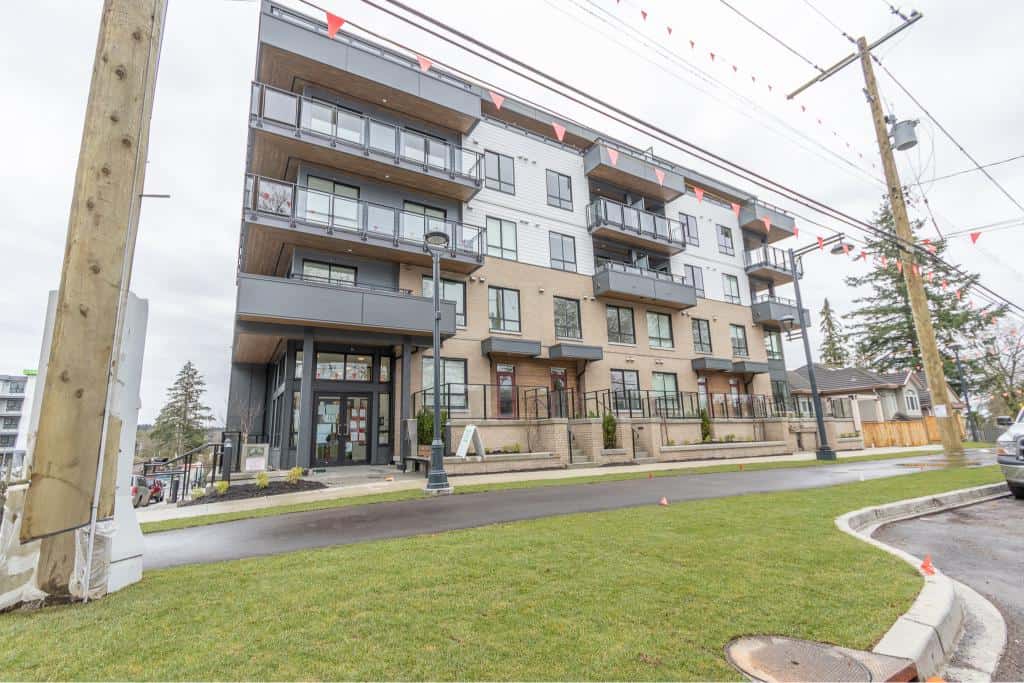 Modern multi-unit residential building with balconies, located in a vibrant neighbourhood, ideal for real estate investment and property management in the Orca Realty Inc. portfolio.