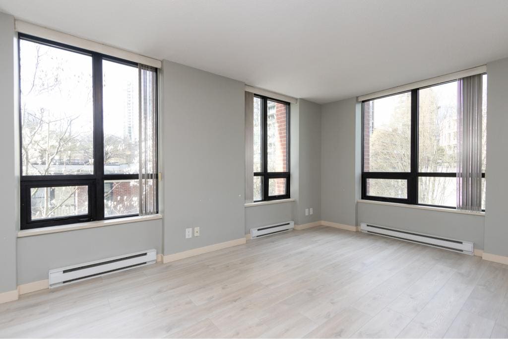 Bright and spacious living room in a modern Vancouver apartment with large windows, natural light, neutral decor, ideal for real estate listings, rentals, and property marketing.