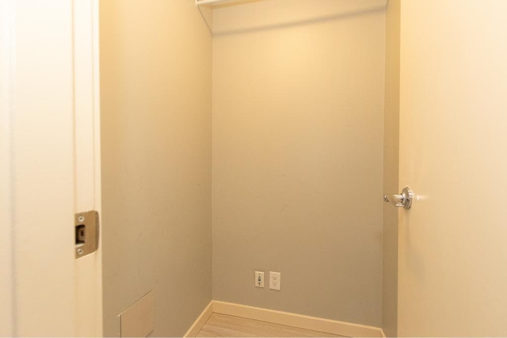 Storage closet interior with neutral-colored walls and electrical outlets for convenience, part of Orca Realty Inc. property listings in BC.
