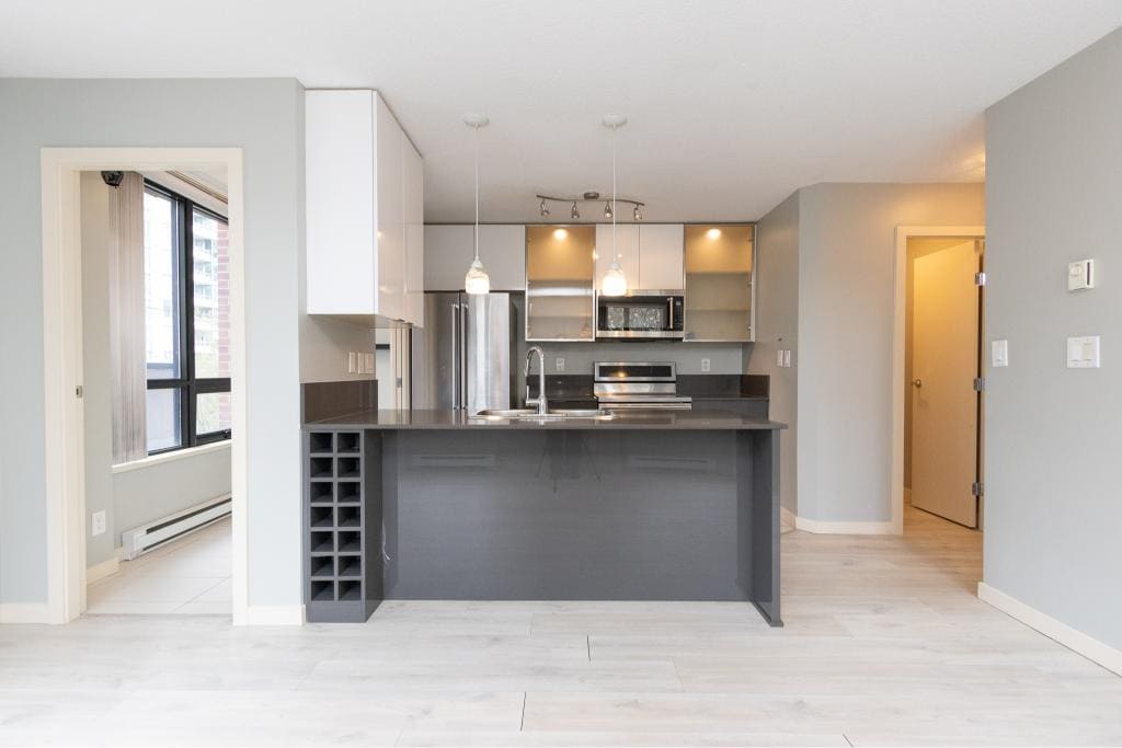 Modern kitchen interior in a Vancouver condo showcasing contemporary appliances and sleek finishes for a stylish urban living experience.