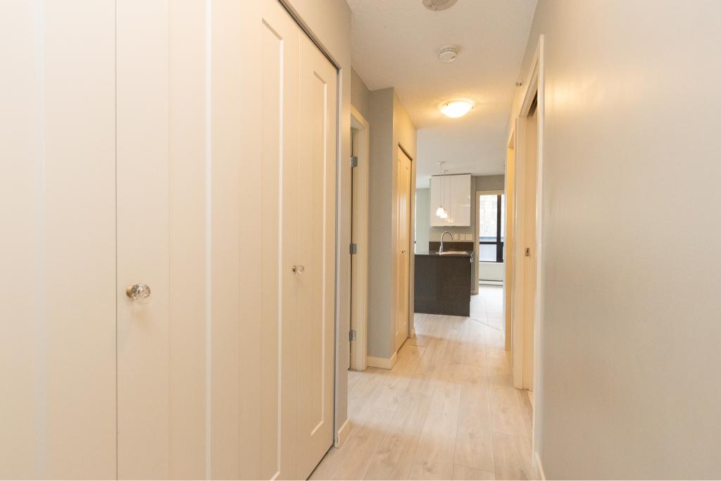Modern hallway leading to open-concept kitchen and living space at Orca Realty Inc., Vancouver Island real estate listing. Perfect for buyers seeking stylish interiors and functional layouts.