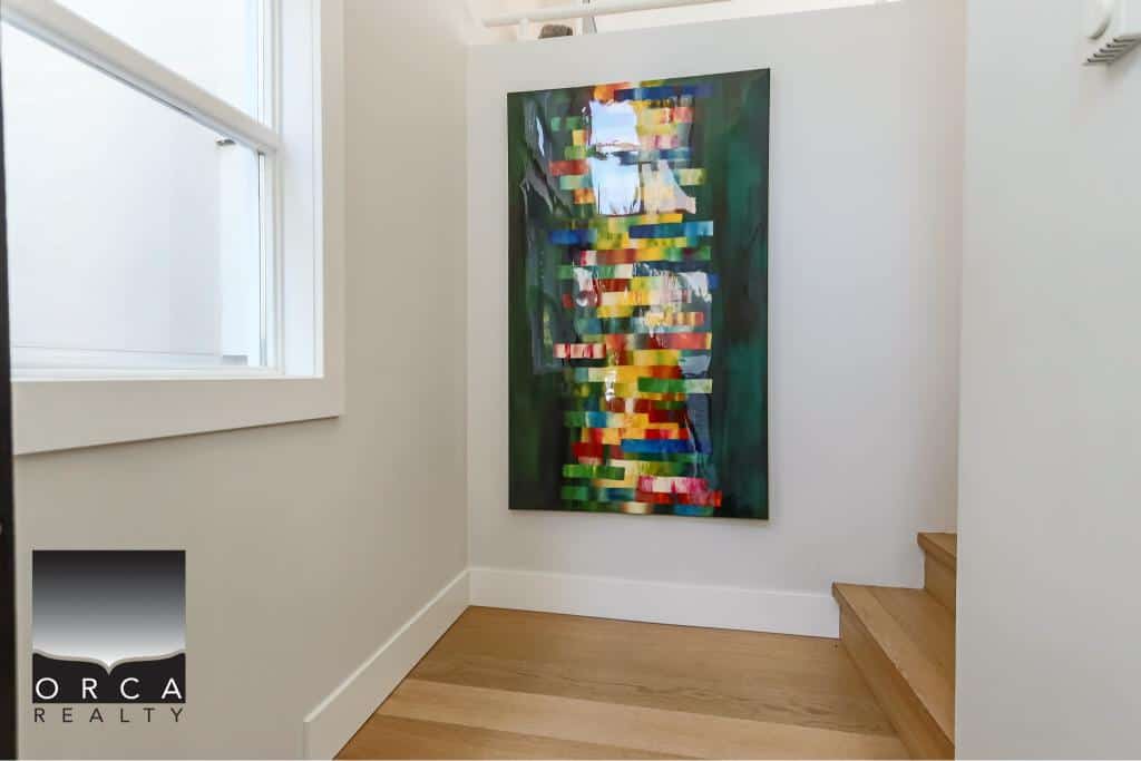 Vibrant abstract artwork hanging in a modern home interior, showcasing contemporary wall art and stylish decor, ideal for real estate listings and interior design showcases.