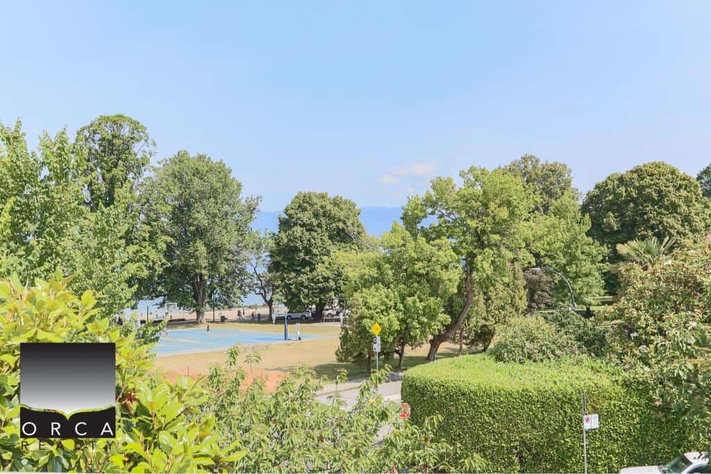 Lush green park with mature trees and recreational area, ideal for outdoor activities and community events in Vancouver, British Columbia.
