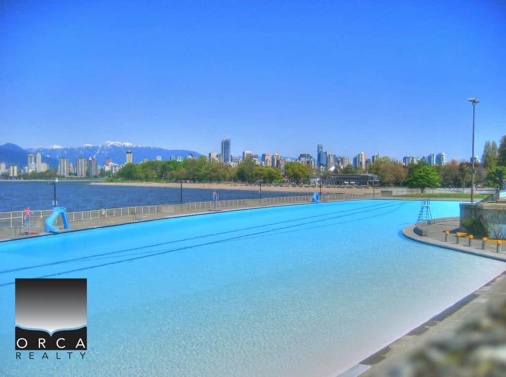 Stunning outdoor swimming pool overlooking Vancouver skyline and mountains, perfect for relaxation and leisure in downtown Vancouver.