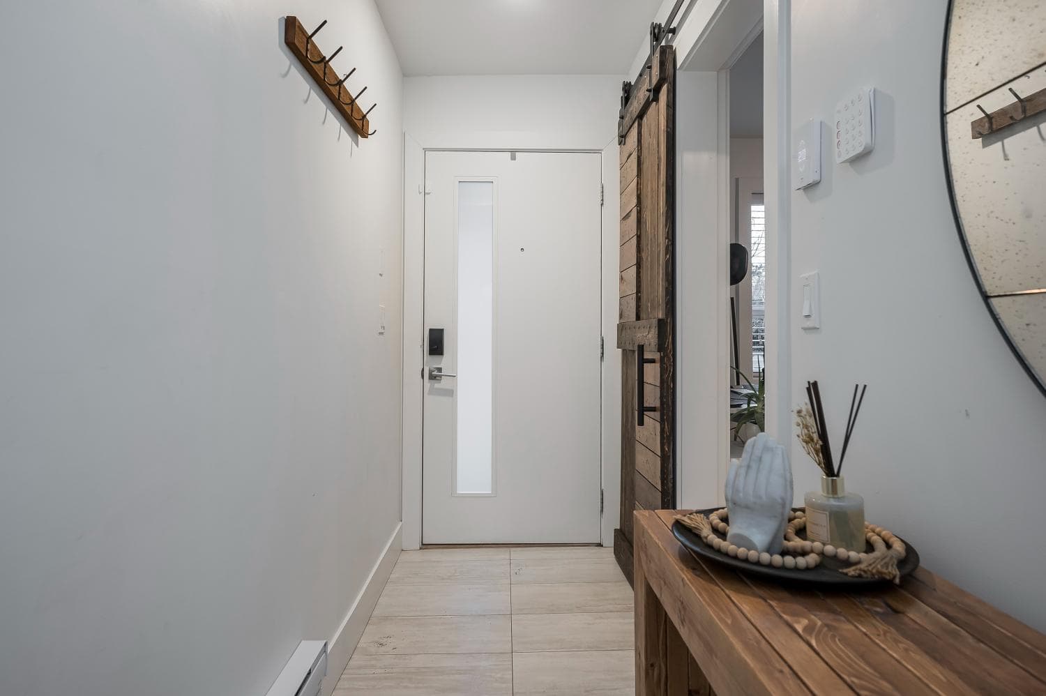 Bright and modern condo entrance with minimalist decor, wooden accents, and stylish decor pieces, perfect for first-time homebuyers and investors seeking Vancouver properties.