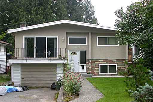 Modern suburban home with a lush front lawn and spacious driveway in a serene neighbourhood in BC. Perfect for families seeking a comfortable residence with attractive curb appeal.