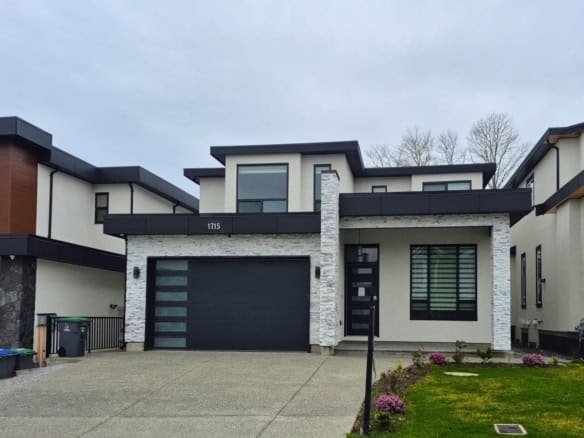 Modern contemporary house with sleek black and white exterior, stone accents, and large windows, showcasing premium real estate listing by Orca Realty Inc. in a desirable neighbourhood.