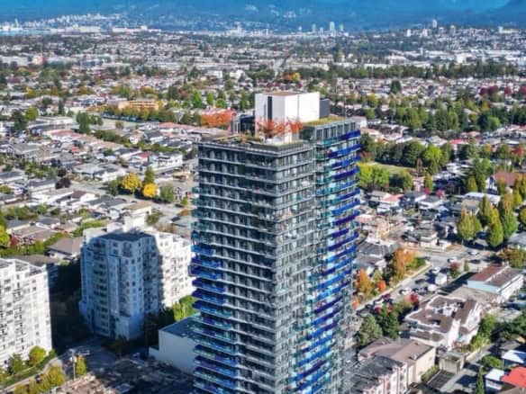 Luxury high-rise condo building in Vancouver with panoramic city skyline views.