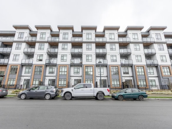 Modern condominium building exterior with multiple floors, balconies, and contemporary design, available through Orca Realty Inc. in Vancouver, BC. Perfect for buyers seeking urban apartments or investment properties.