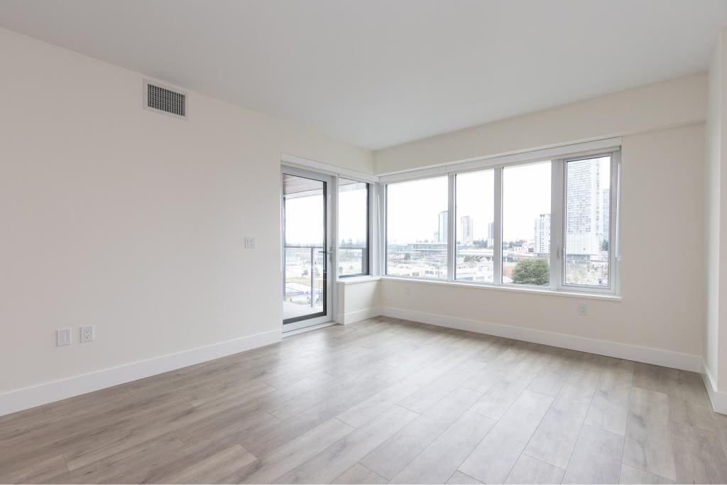 Bright modern city-view apartment living room with large windows in Vancouver, BC, showcasing contemporary design and natural light, perfect for Toronto real estate buyers.