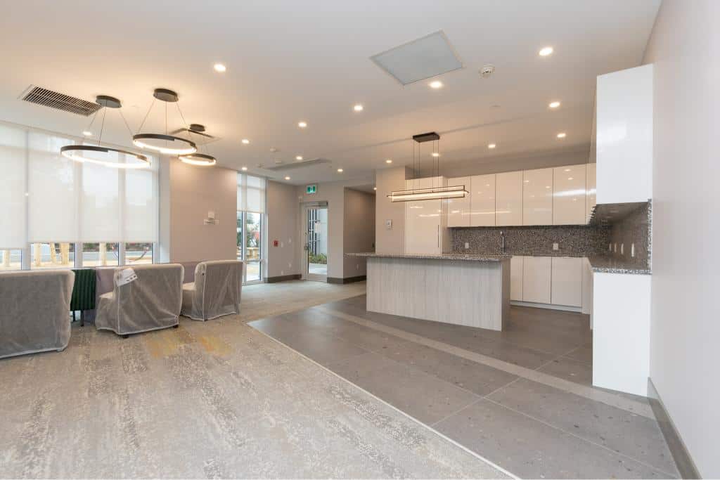 Modern open-concept living space with contemporary kitchen and stylish furnishings, ideal for residential or commercial properties in Victoria.