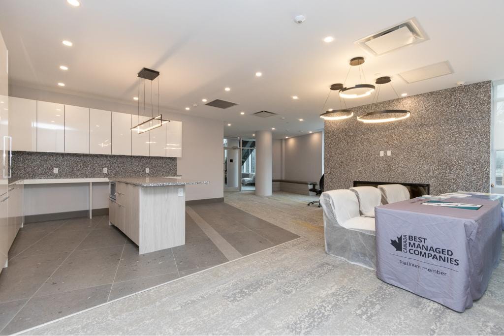 Modern interior of a luxury condo showing a sleek kitchen and inviting dining area in a high-end property, with contemporary lighting and stylish finishes, representing Orca Realty Inc.