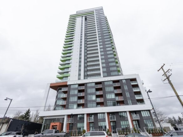 Modern high-rise condominium building in Vancouver, BC, featuring contemporary architecture with glass balconies and green accent elements, perfect for luxury urban living.