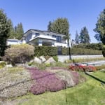 Elegant modern home with landscaped garden in Vancouver, BC, showcasing luxury real estate by Orca Realty Inc. in a scenic neighbourhood.