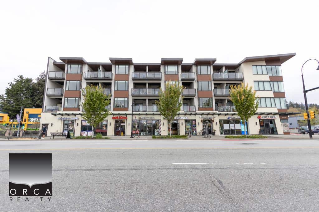 Modern mixed-use residential and commercial building in Victoria, BC with retail shops and apartments, ideal for real estate investment and urban living.
