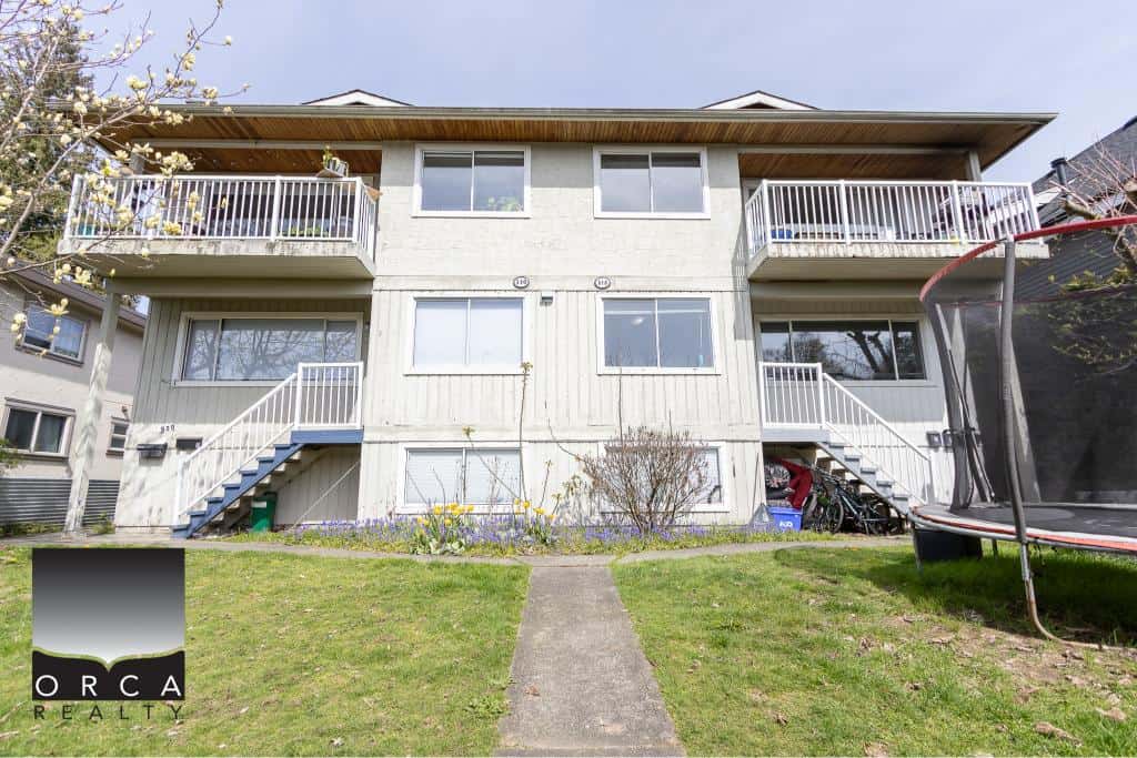 Bright multi-family residential building with balconies on each floor in a peaceful neighborhood. Ideal for real estate investors or families looking for Vancouver properties.