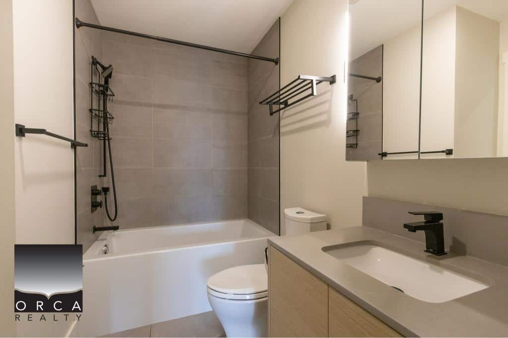 Modern bathroom with neutral tones, walk-in shower, sleek vanity, and contemporary fixtures, perfect for Vancouver Island residential or investment properties.