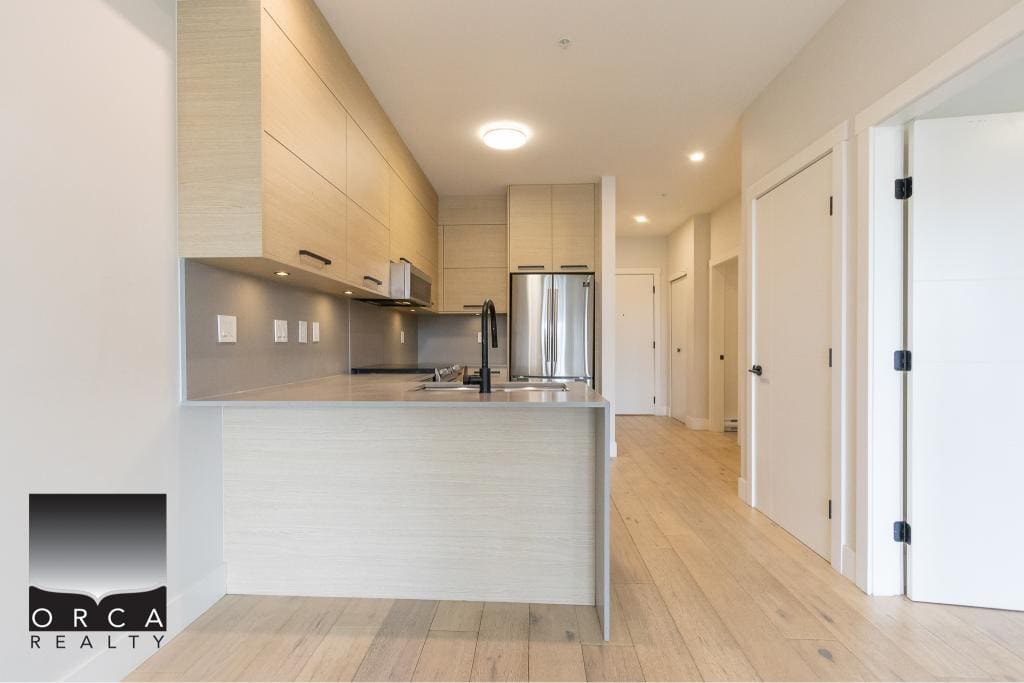 Modern kitchen in a Toronto condo with sleek cabinetry and stainless steel appliances. Perfect for urban living and real estate investment in Ontario.