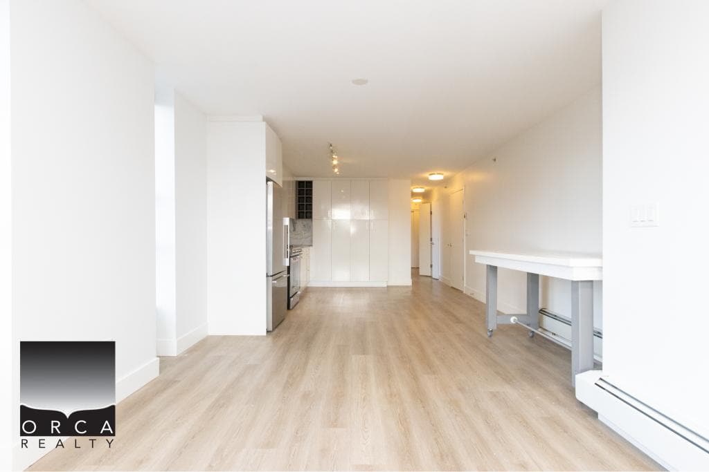 Spacious and bright interior of a Vancouver condo located at 407-231 E Pender St, featuring open living space, hardwood floors, and contemporary design, ideal for urban living.