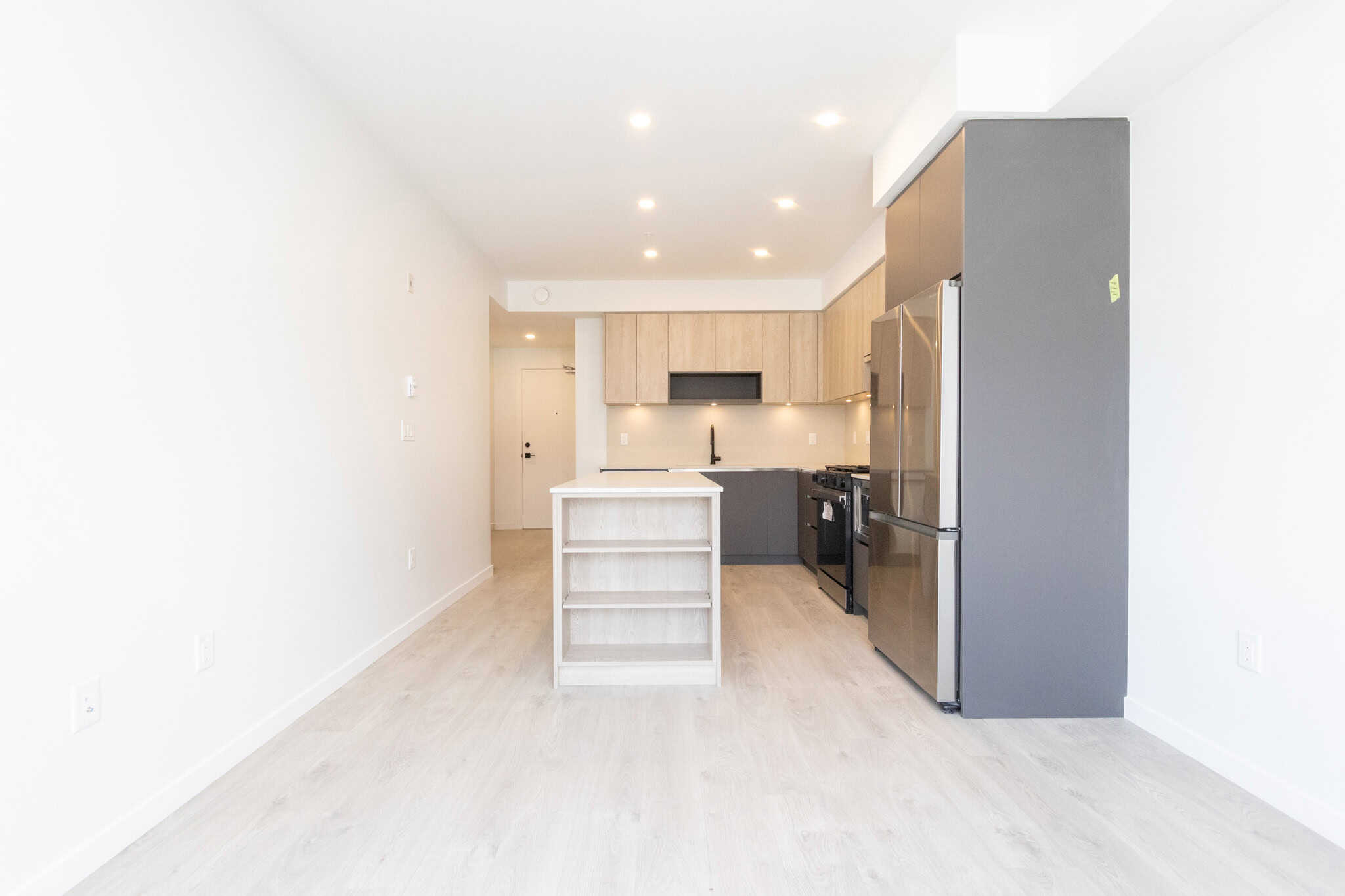 Modern open-concept kitchen with sleek cabinetry, stainless steel appliances, and bright lighting, perfect for Vancouver-area homes.