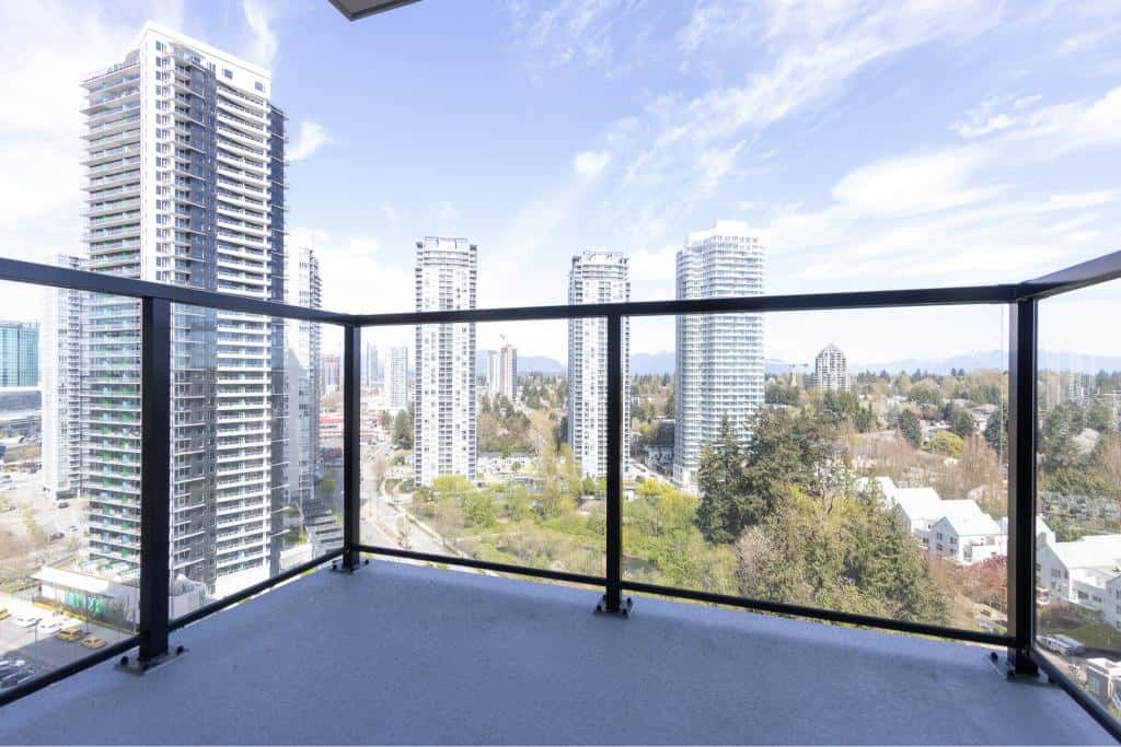 Modern high-rise city view from a balcony in Vancouver, BC, showcasing luxury condo living with tall buildings, scenic skyline, and urban lifestyle in the downtown core.