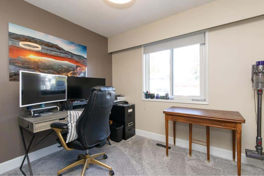 Modern home office with dual monitors, ergonomic chair, and natural light, ideal for remote work or real estate activities in Vancouver, BC. Perfect for clients seeking professional property management or realty services.