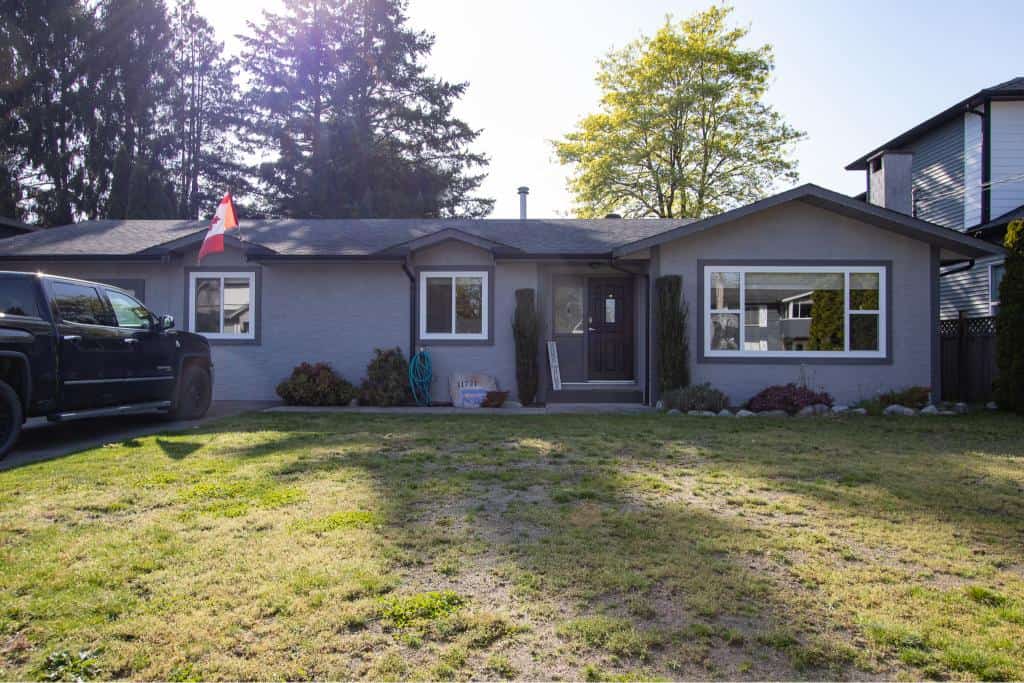 Charming single-family home for sale in Victoria, BC, featuring a beautifully landscaped yard, modern exterior design, and prime location near amenities and parks, offered by Orca Realty Inc.