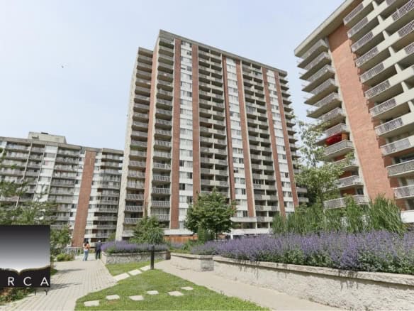 Modern high-rise condo building in Vancouver BC featuring spacious balconies and lush landscaped gardens, ideal for real estate investment and urban living.