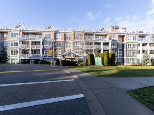 Modern multi-family residential apartment complex in Victoria, BC, showcasing contemporary architecture, well-maintained landscaping, and spacious balconies. Perfect for real estate investment or living options in BC.
