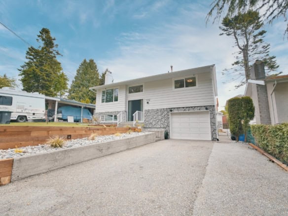 Spacious suburban house with a well-maintained driveway, modern exterior, and inviting front entrance, ideal for family living and real estate investment.