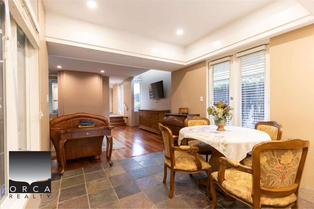 Spacious living and dining area with elegant furniture, hardwood floors, and large windows; perfect for family living and entertaining in a beautiful Canadian home.