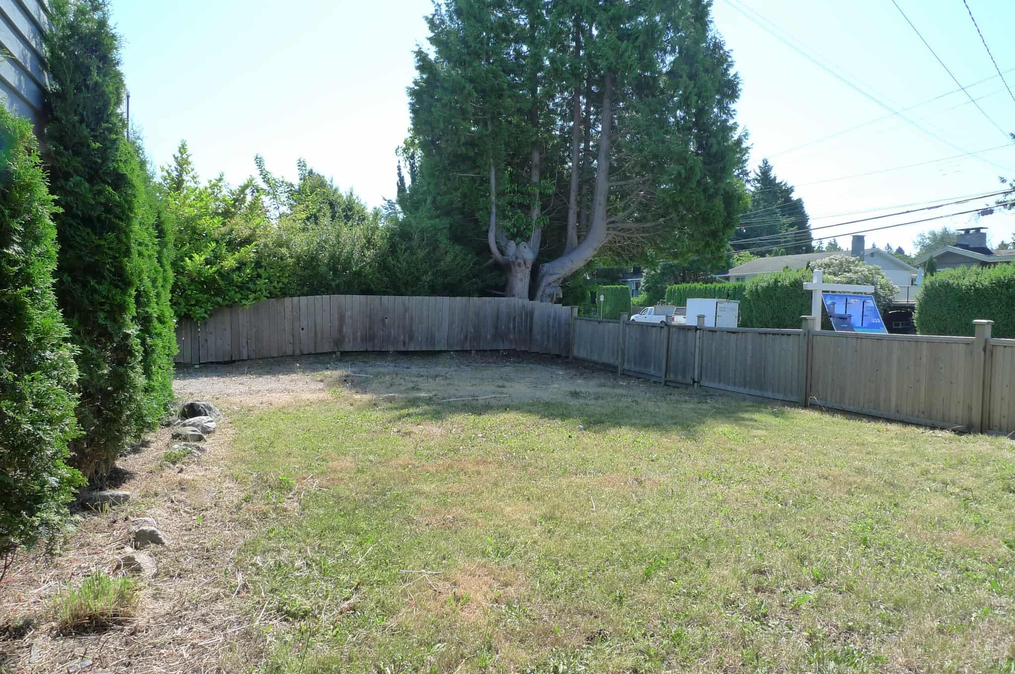 Vacant lot for sale with mature trees and privacy fencing in a desirable neighbourhood in Victoria, BC. Ideal for building your dream home or investment property, close to amenities and parks.