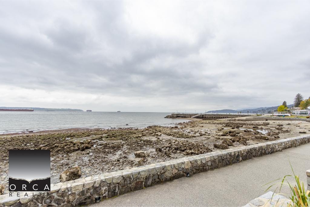 Scenic coastal view with rocky shoreline and seawall, offering a serene waterfront setting ideal for real estate investments, properties, or development opportunities along BC's shoreline.
