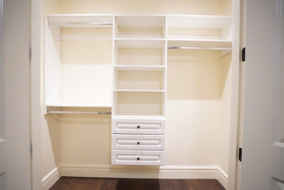 Spacious walk-in closet with built-in shelves and drawers, ideal for organized storage solutions. Perfect for listing local homes in Vancouver and surrounding areas, showcasing property features.