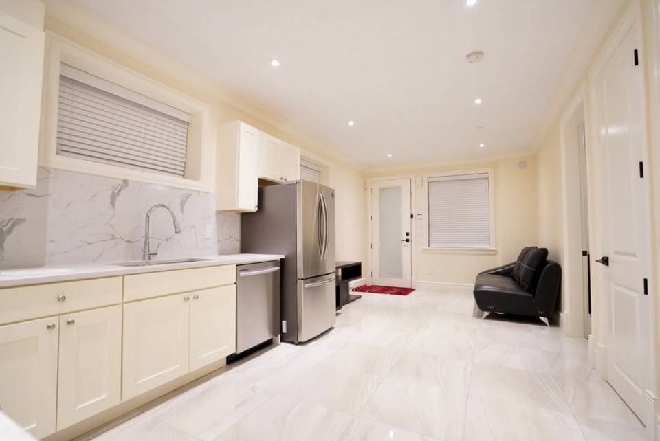 Bright modern kitchen with stainless steel appliances and white cabinetry, perfect for home chefs and family living.