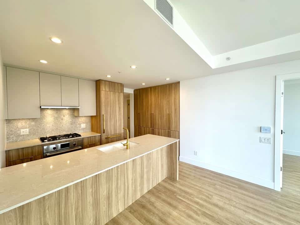 Modern kitchen with wood cabinets and white countertops, ideal for Vancouver homebuyers seeking stylish real estate in BC.