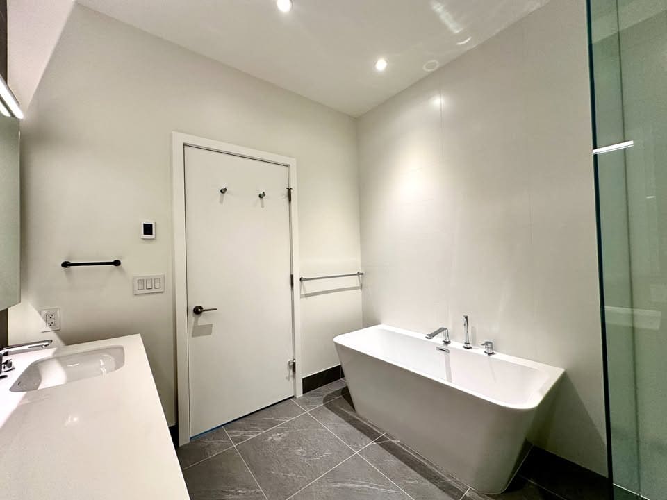 Modern bathroom with freestanding bathtub, contemporary fixtures, and minimalist design, perfect for luxury Vancouver or Victoria real estate properties.